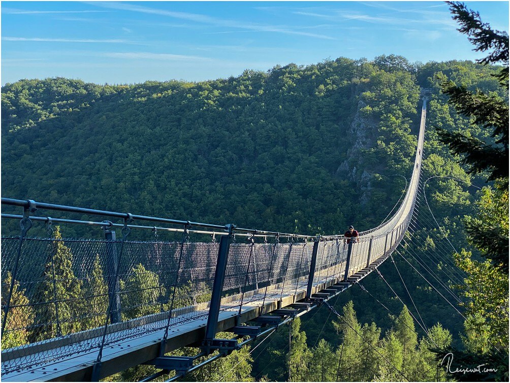 Ein einsamer Wanderer läuft früh Morgens über die Hängeseilbrücke Geierlay